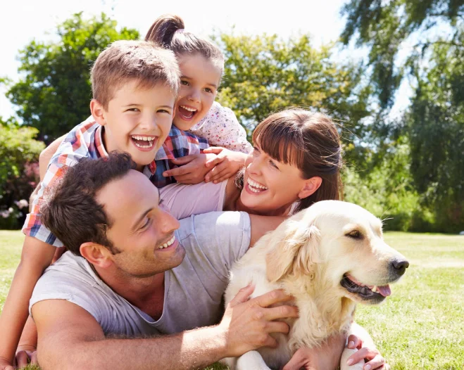 family hanging out at yard with their pet dog